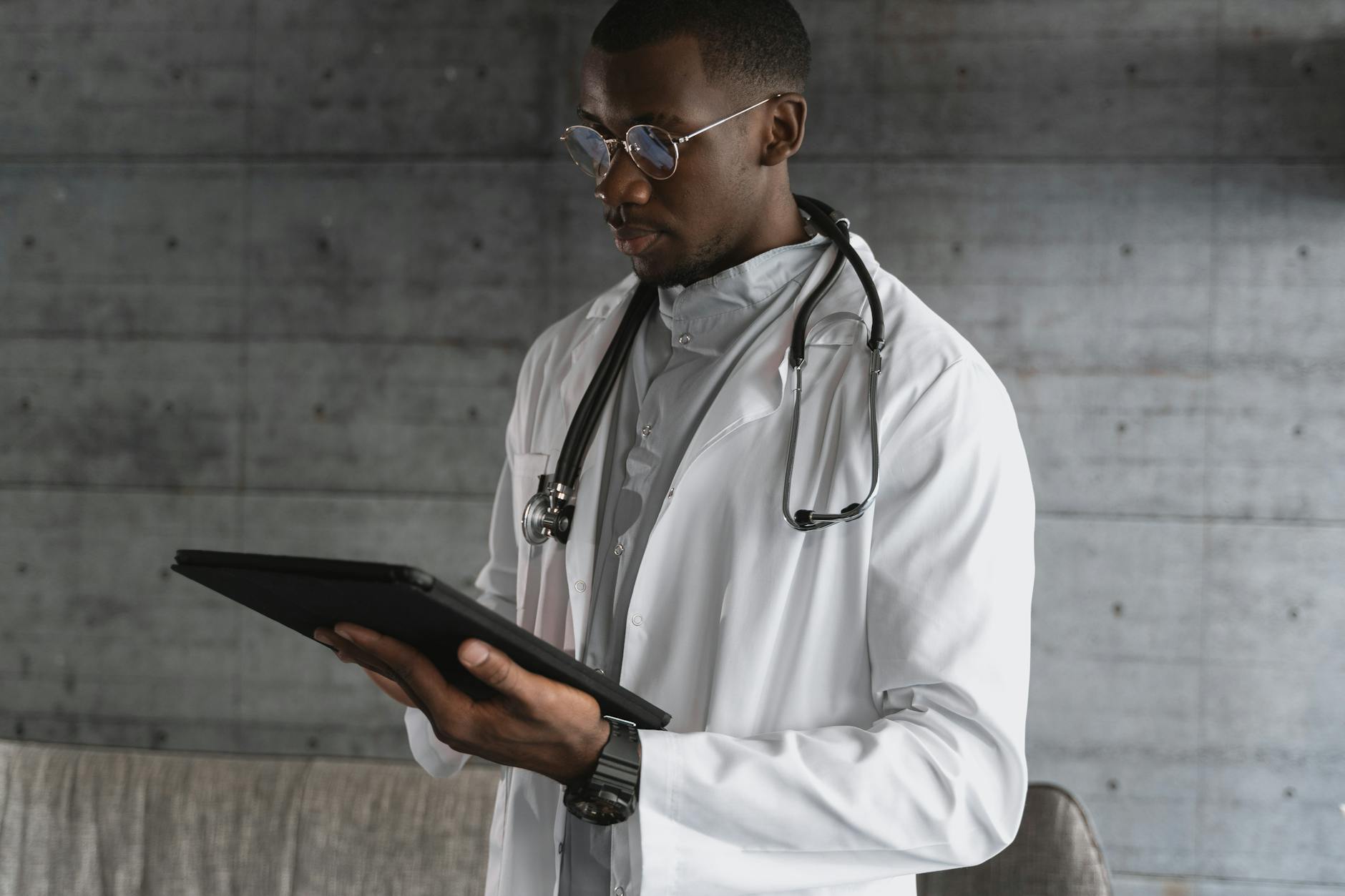 Healthcare professional using a tablet in a modern medical office