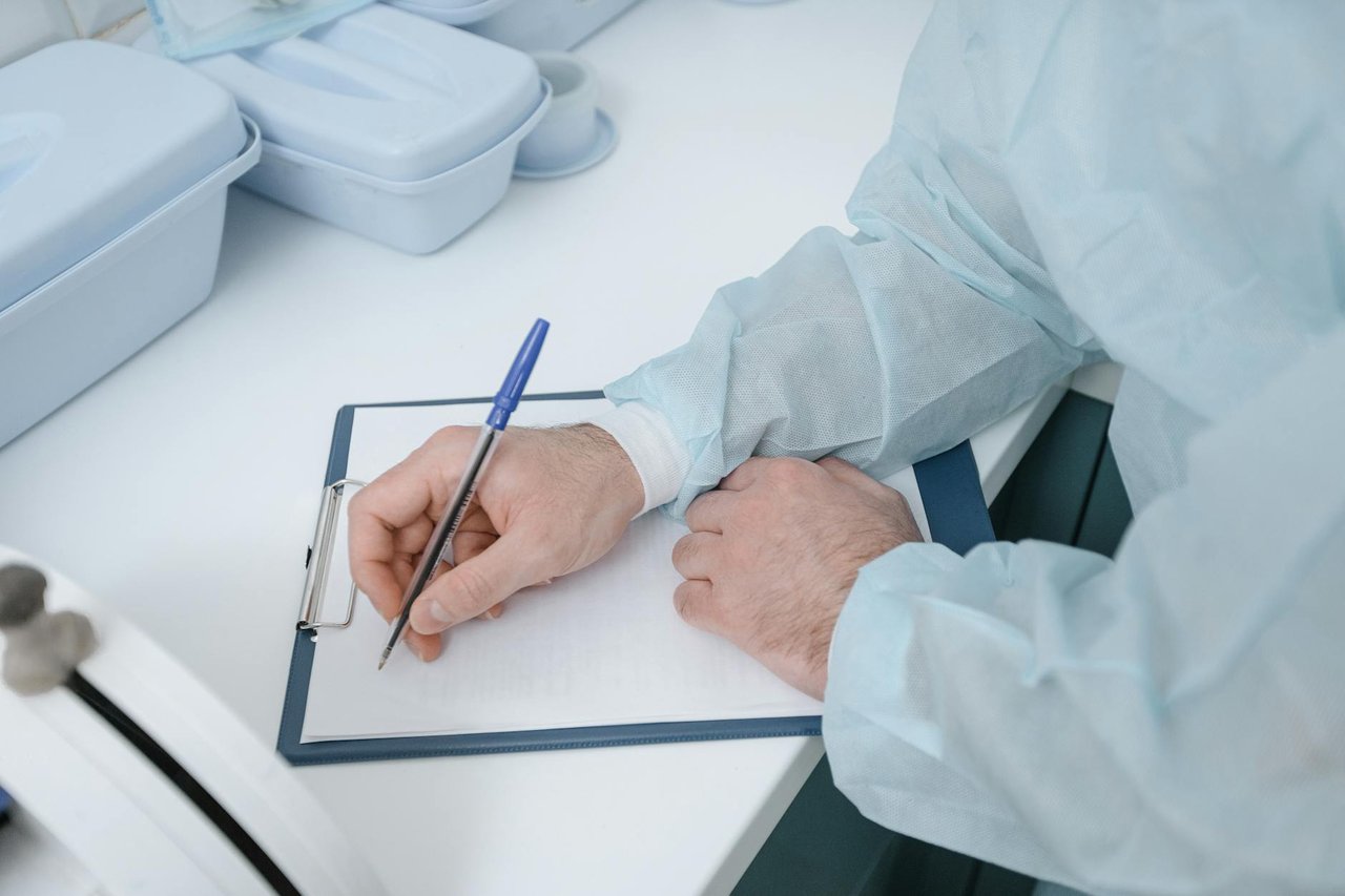 Medical professional reviewing documents at a desk